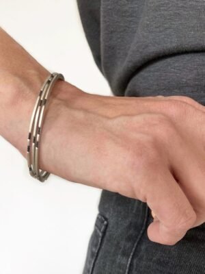 Asymmetrical sterling silver bangle with oxidized details in minimalist design