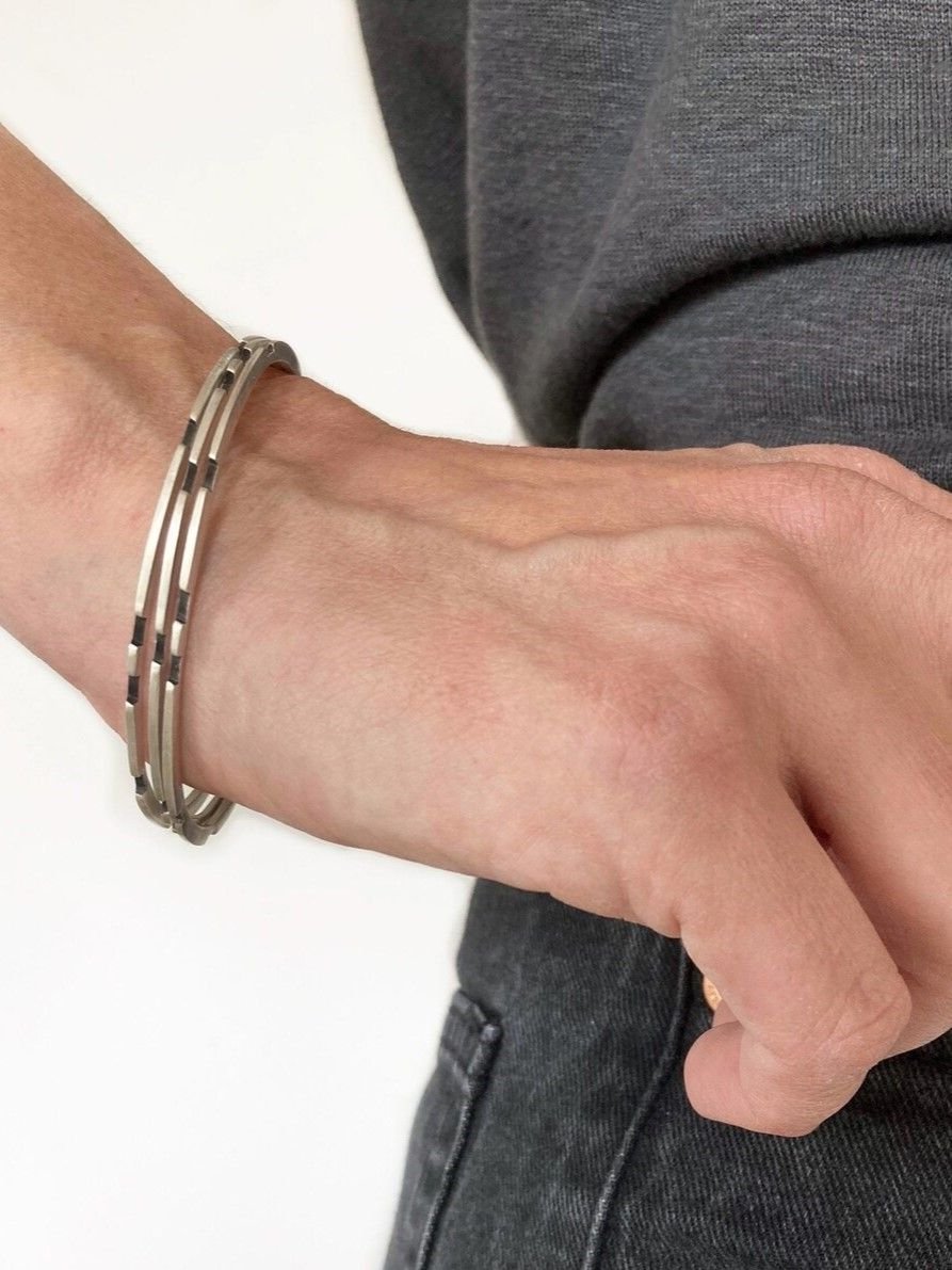 Asymmetrical sterling silver bangle with oxidized details in minimalist design