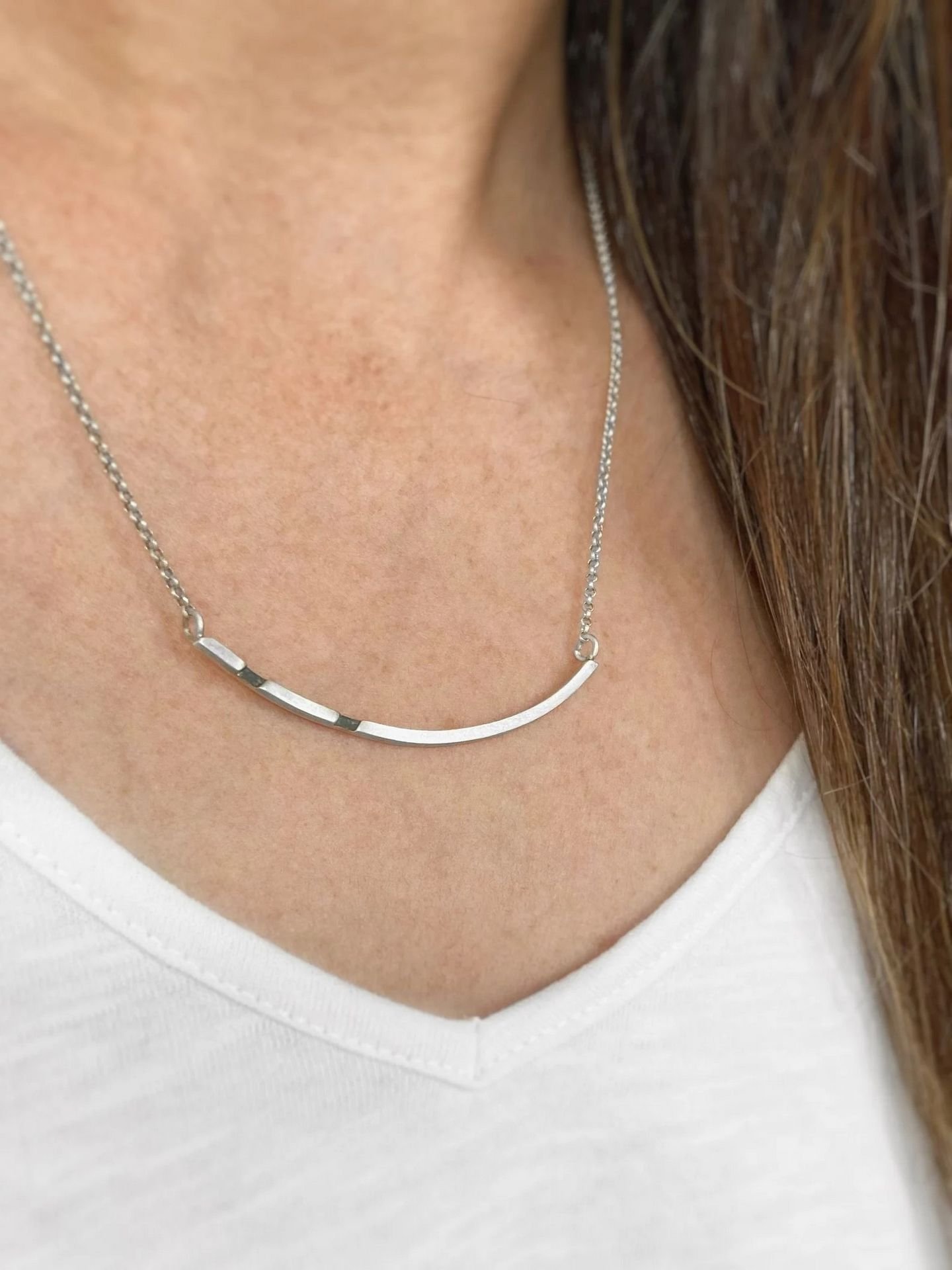 Third image of product: Asymmetrical sterling silver necklace with oxidized details in minimalist design