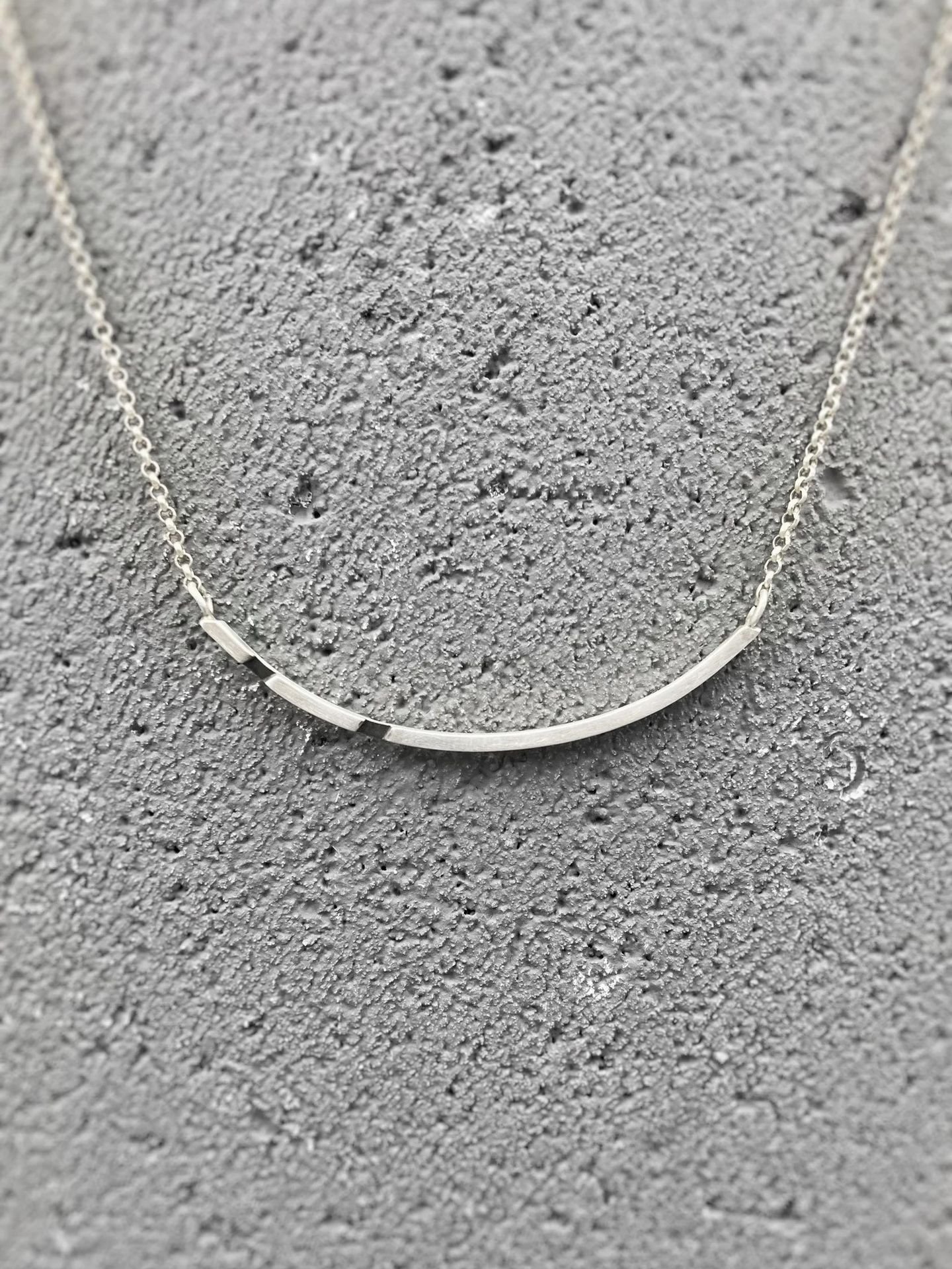 Asymmetrical sterling silver necklace with oxidized details in minimalist design