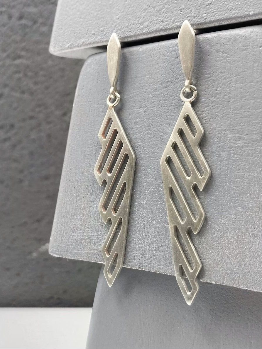 Modern sterling silver hoop earrings with oxidized details